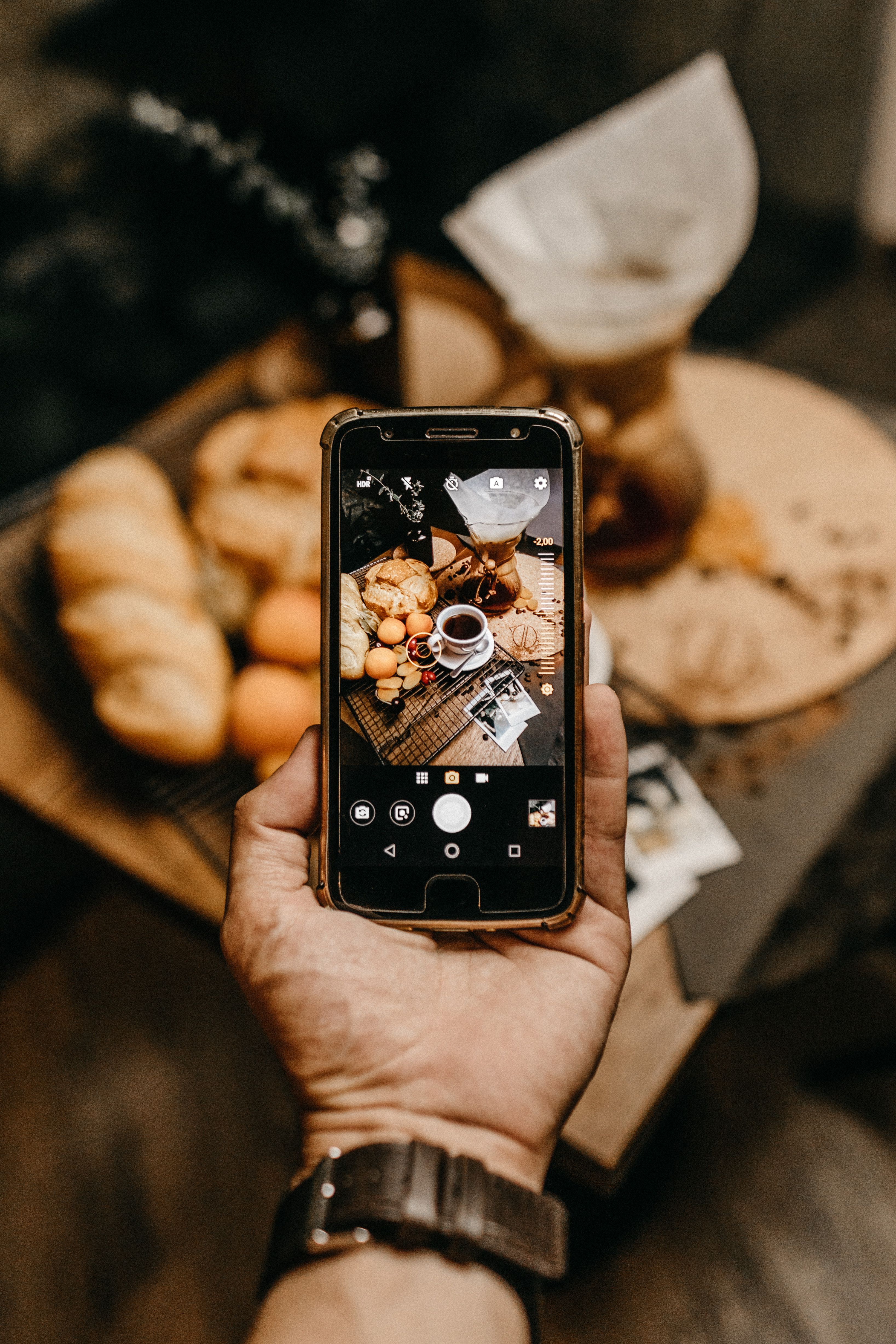 iPhone held up showing a restaurant's social media feed